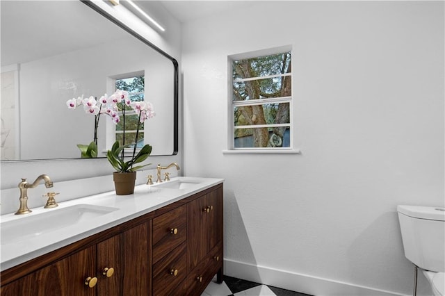 bathroom featuring vanity and toilet