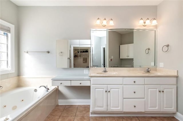 full bath with tile patterned flooring, a sink, a tub with jets, and double vanity