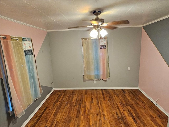 empty room with ceiling fan, ornamental molding, wood finished floors, and baseboards