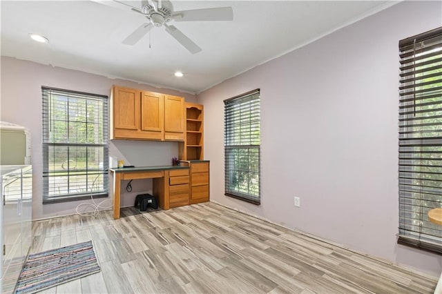 office area with plenty of natural light, ceiling fan, and light wood-type flooring