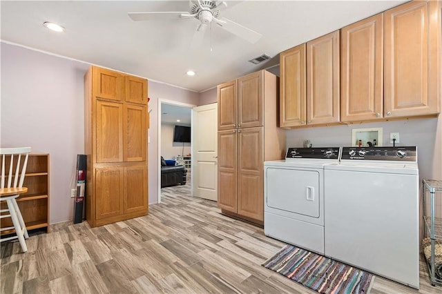 washroom featuring cabinets, ceiling fan, light hardwood / wood-style floors, washer hookup, and washing machine and clothes dryer