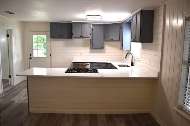 6208 Anthony Dr W, Theodore, AL 36582 - kitchen with dark wood-style flooring, a sink, light countertops, gray cabinets, and a peninsula
