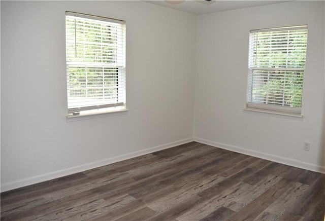 6208 Anthony Dr W, Theodore, AL 36582 - spare room featuring a healthy amount of sunlight, baseboards, and dark wood-style flooring