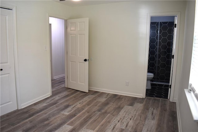 6208 Anthony Dr W, Theodore, AL 36582 - unfurnished bedroom featuring baseboards, ensuite bath, and wood finished floors