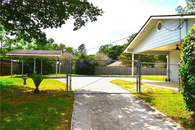 6208 Anthony Dr W, Theodore, AL 36582 - view of gate with a yard, fence, and a ceiling fan