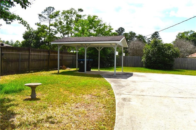 6208 Anthony Dr W, Theodore, AL 36582 - view of yard with fence, a carport, and concrete driveway