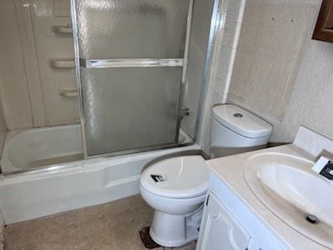 full bathroom featuring enclosed tub / shower combo, toilet, and vanity