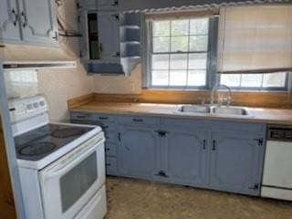 kitchen featuring plenty of natural light, white appliances, open shelves, and a sink