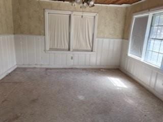 empty room with a wainscoted wall