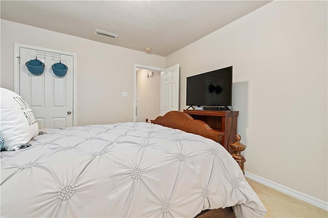 carpeted bedroom with a textured ceiling