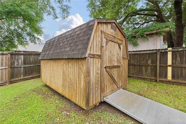 view of outbuilding featuring a lawn