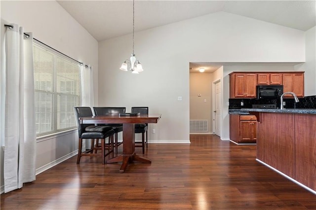 dining space with dark wood-type flooring, a chandelier, and high vaulted ceiling