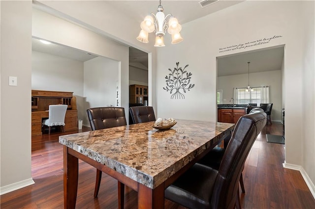 dining room with an inviting chandelier and dark hardwood / wood-style flooring