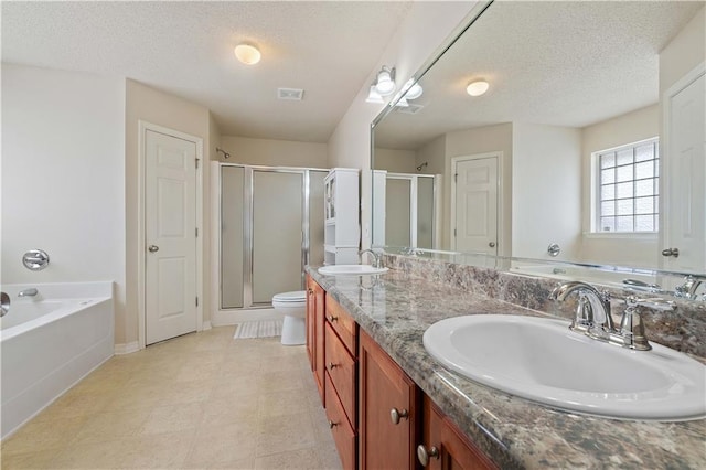 full bathroom featuring independent shower and bath, vanity, a textured ceiling, and toilet