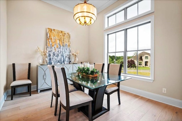 dining space featuring plenty of natural light, an inviting chandelier, and light wood-type flooring