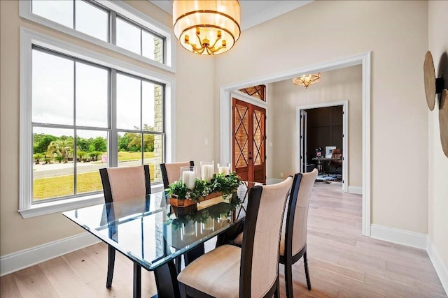 dining room featuring light hardwood / wood-style flooring and an inviting chandelier