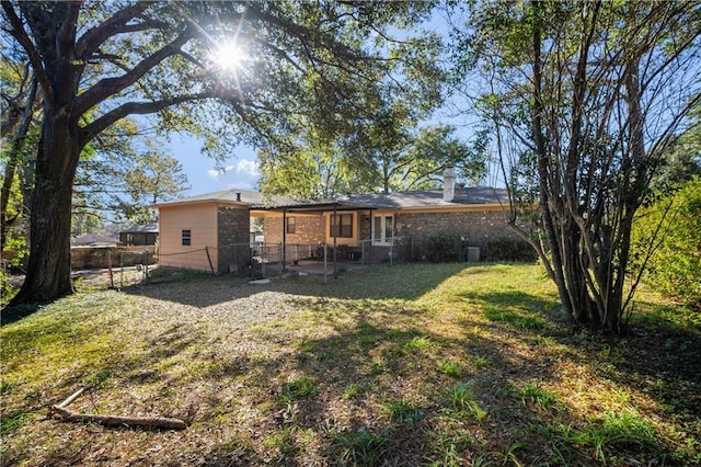 rear view of house featuring a lawn