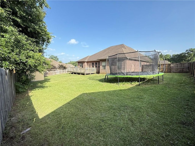 3434 Charleston Dr, Saraland, AL 36571 - view of yard with a trampoline and a wooden deck