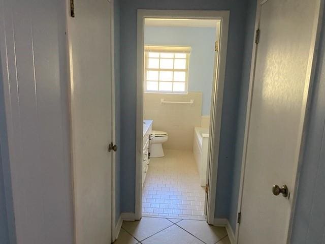 bathroom featuring tile patterned flooring, vanity, and toilet