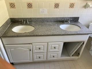 bathroom featuring tile patterned flooring, vanity, tasteful backsplash, and toilet