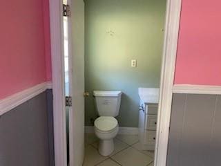 bathroom featuring toilet and tile patterned floors