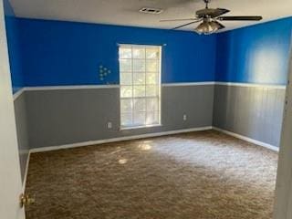 carpeted spare room featuring ceiling fan