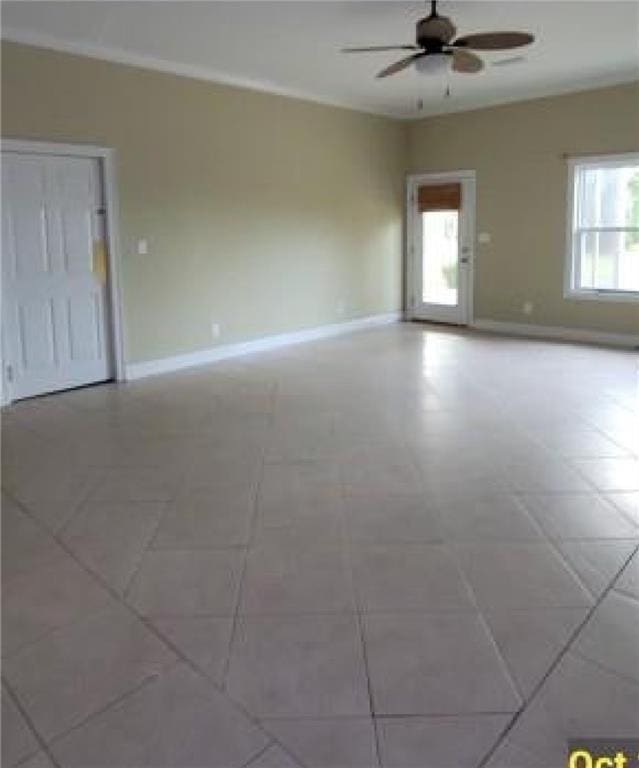 spare room with tile patterned floors and ceiling fan