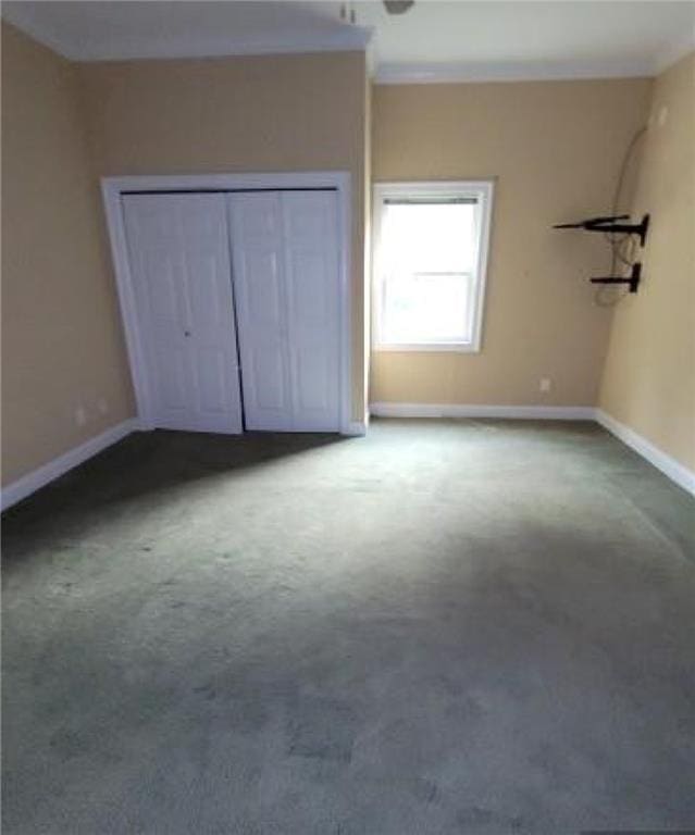 unfurnished bedroom featuring carpet and a closet