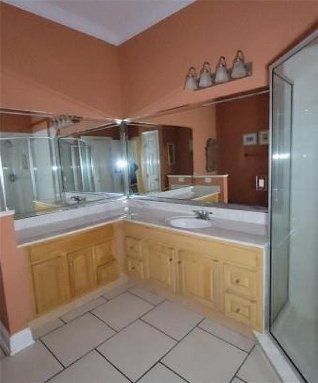 bathroom featuring vanity, an enclosed shower, and tile patterned floors