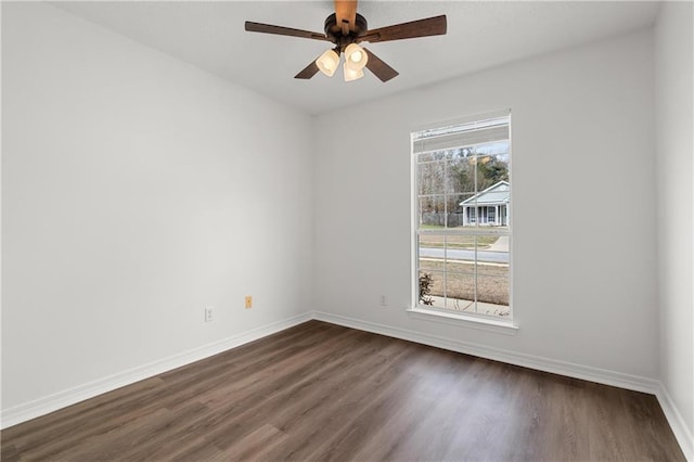 spare room featuring ceiling fan and dark hardwood / wood-style flooring