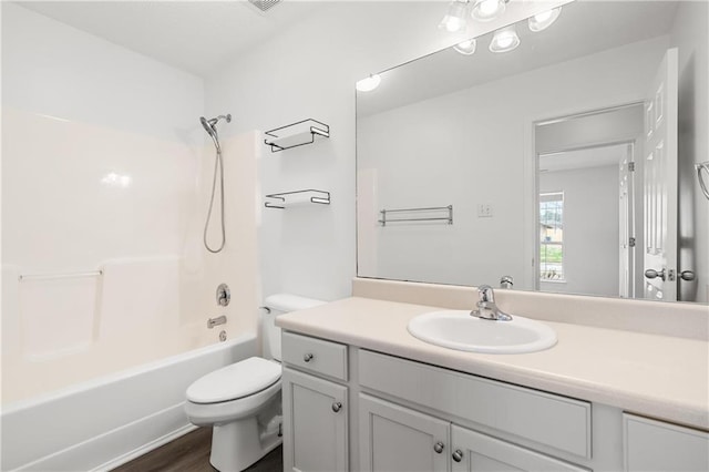 full bathroom featuring hardwood / wood-style flooring,  shower combination, toilet, and vanity