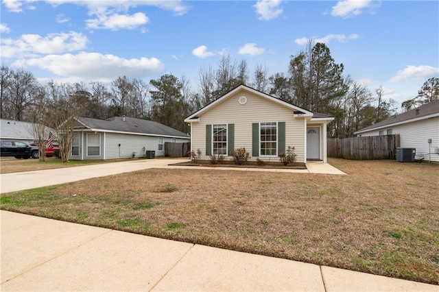 ranch-style home with cooling unit and a front yard