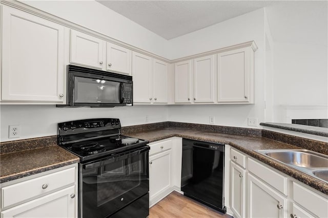 kitchen featuring white cabinetry, sink, light hardwood / wood-style flooring, and black appliances