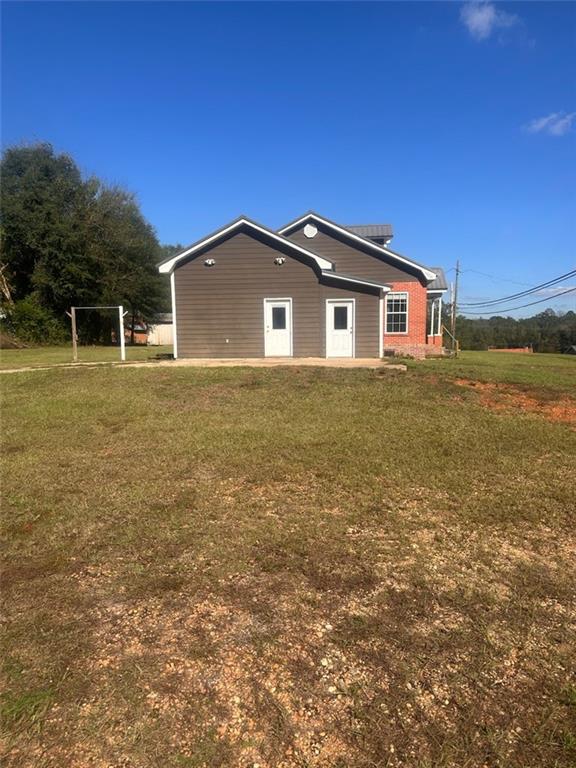 view of side of property featuring a yard