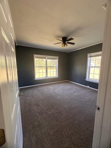 carpeted spare room with ceiling fan and ornamental molding