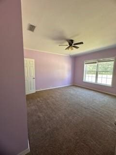 empty room featuring ceiling fan and dark carpet