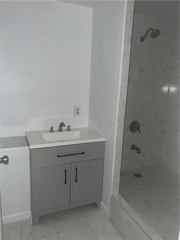 bathroom with vanity and a tile shower