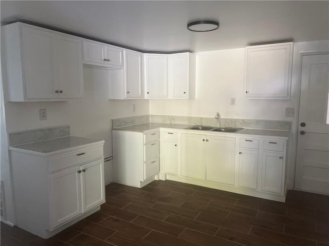 kitchen featuring sink and white cabinets