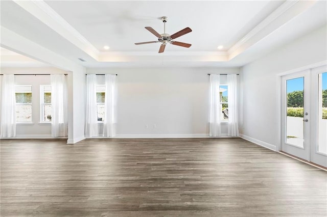 unfurnished living room with french doors, hardwood / wood-style floors, a tray ceiling, and ceiling fan