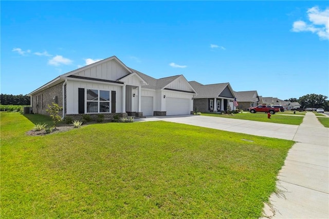 view of front of property with board and batten siding, a front lawn, driveway, and an attached garage