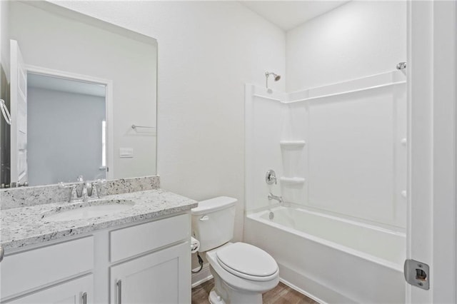 bathroom with wood finished floors, shower / bath combination, vanity, and toilet