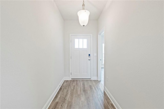 entryway with light wood-type flooring and baseboards