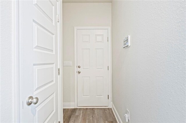 entryway with light wood finished floors and baseboards