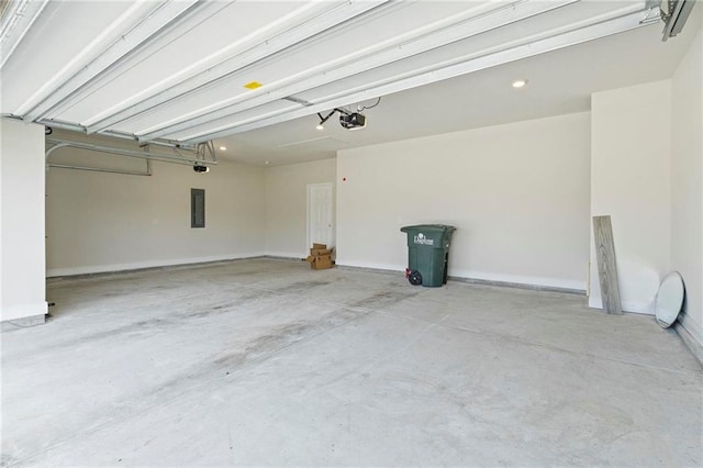 garage with baseboards, electric panel, and a garage door opener