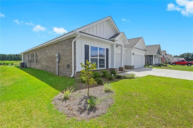 view of front of home with central air condition unit, a front yard, and a garage