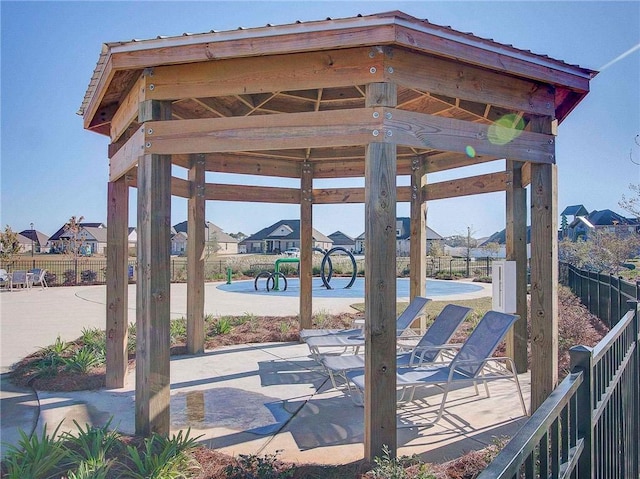 view of property's community featuring fence and a gazebo