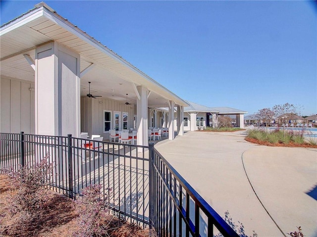 view of patio / terrace featuring ceiling fan, covered porch, and fence