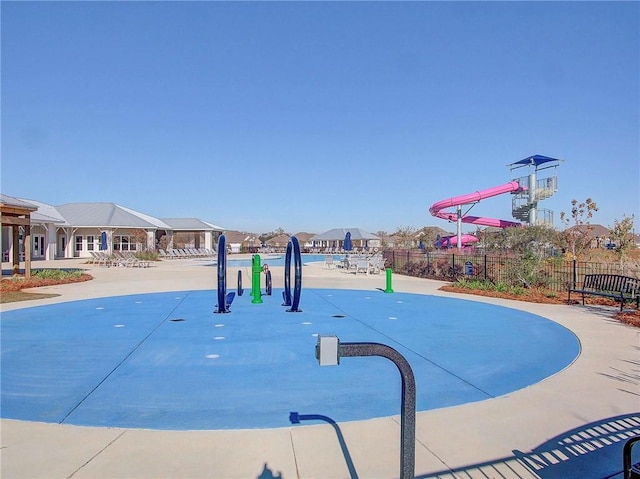 view of basketball court featuring fence