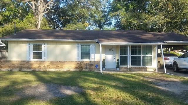 ranch-style home featuring a front yard and a carport