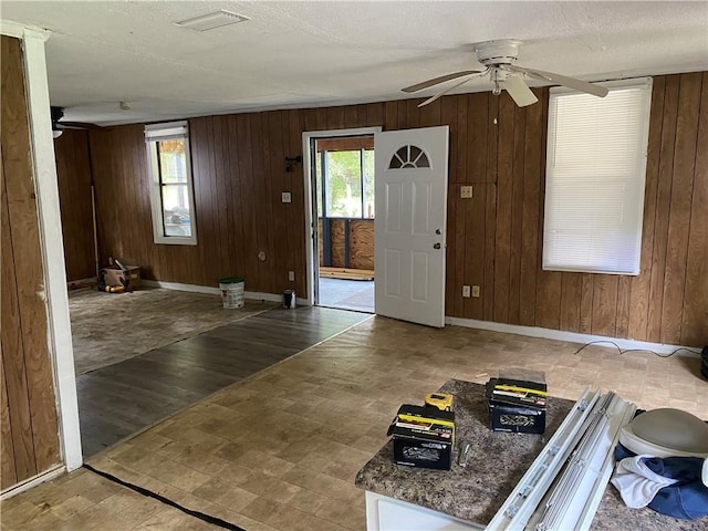 236 Bishop Phillips Ave, Mobile, AL 36608 - foyer entrance featuring wood walls, ceiling fan, and a textured ceiling